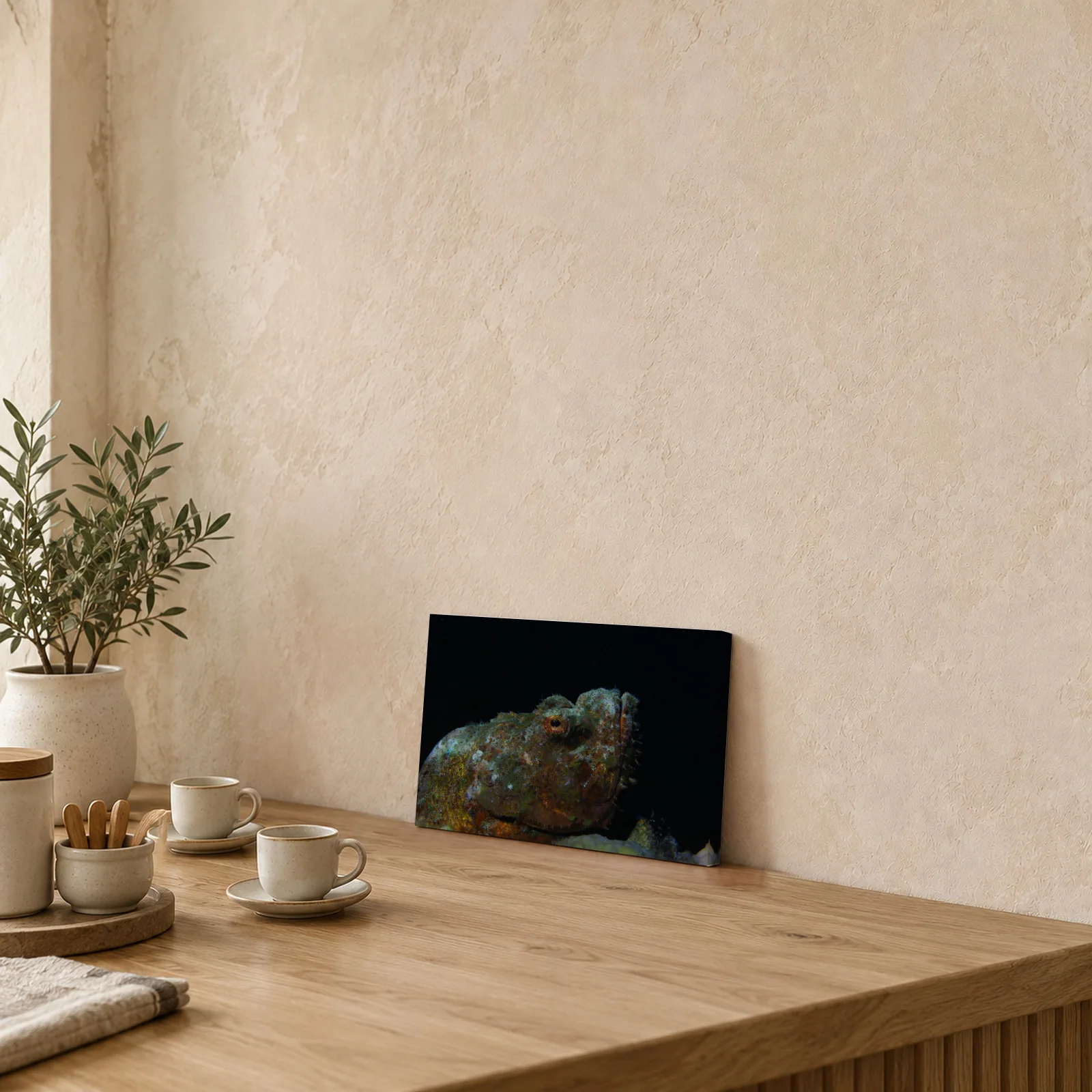 Small false stonefish canvas print on a wooden counter, leaning against the wall